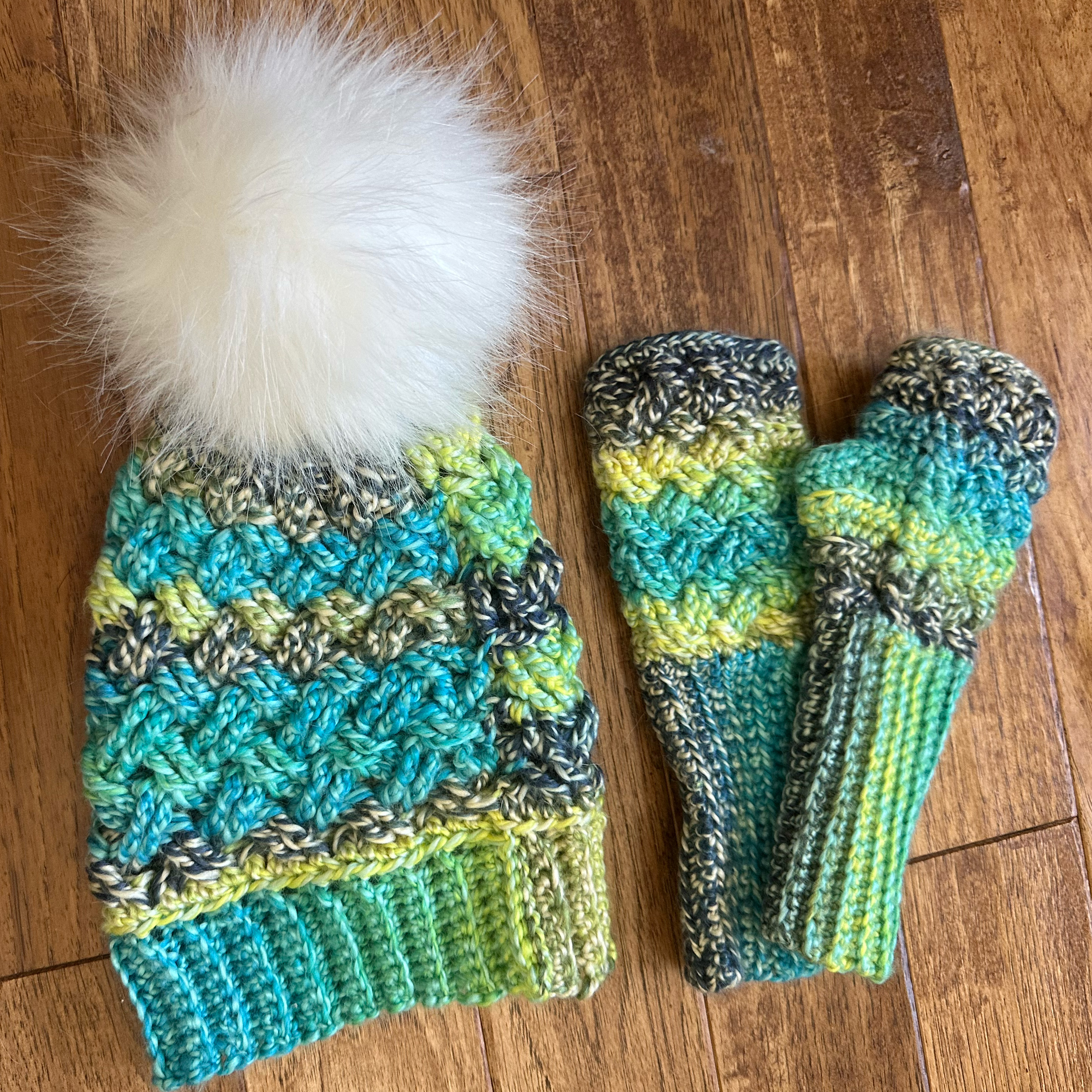 A crochet hat and matching gloves